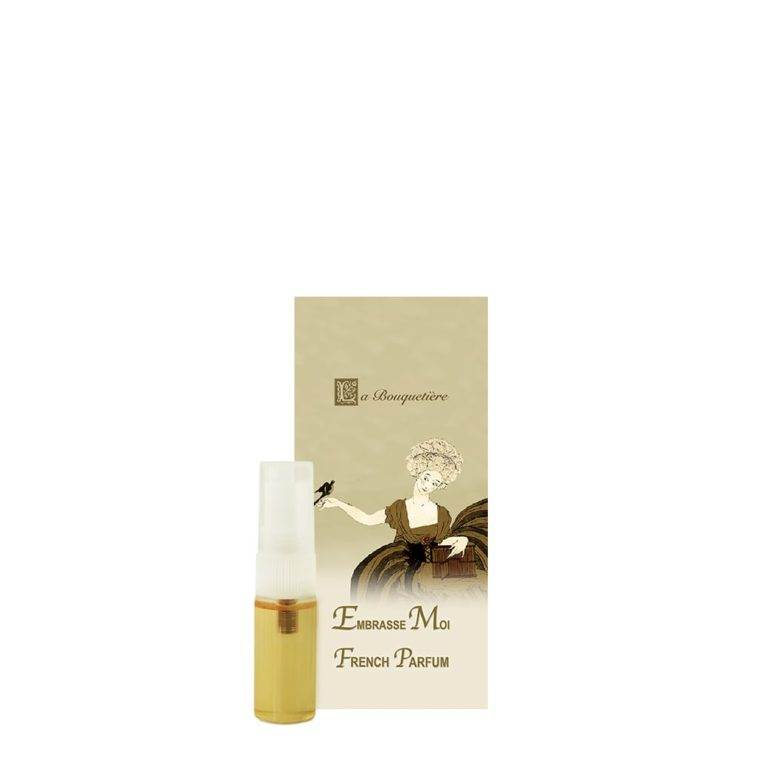 Embrasse Moi Parfum sample spray 0.1oz with elegant packaging, featuring notes of rose, violet, vanilla, musk, cedarwood, and green apple.