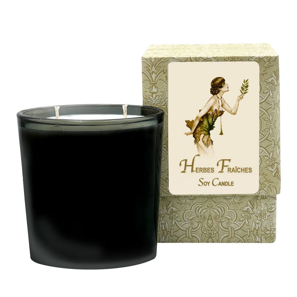 Herbes Fraiches Medium Candle in oval glass jar with 70-hour burn time and aromatic scent notes of green apple and clove.